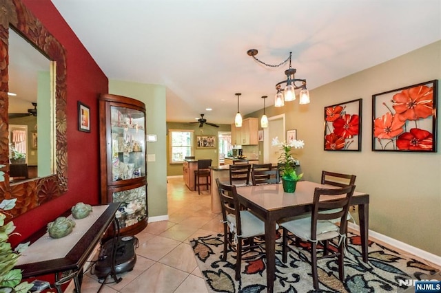 dining space featuring light tile patterned floors, baseboards, and a ceiling fan