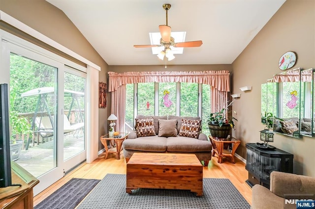 sunroom with a wealth of natural light and a wood stove