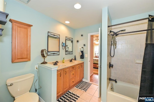 full bath with a sink, tile patterned flooring, toilet, and shower / bath combination