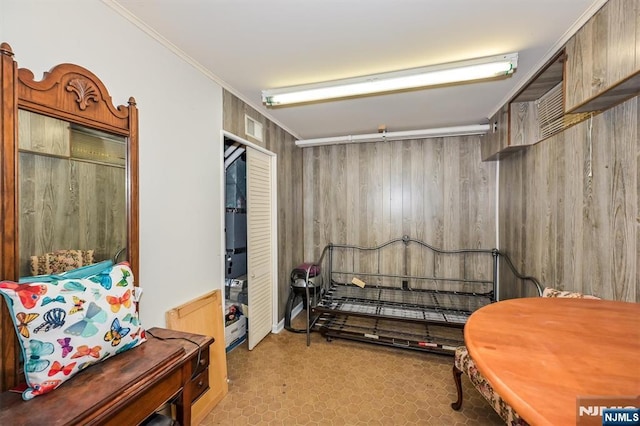living area with wooden walls and tile patterned floors