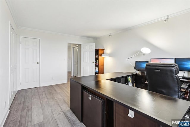 office space featuring crown molding, baseboards, and light wood-style flooring