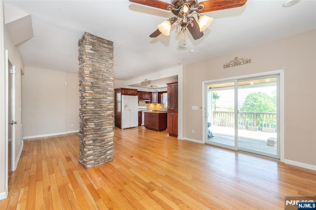 516 5th St, Carlstadt, NJ 07072 - unfurnished living room with ornate columns, a ceiling fan, baseboards, and light wood-type flooring