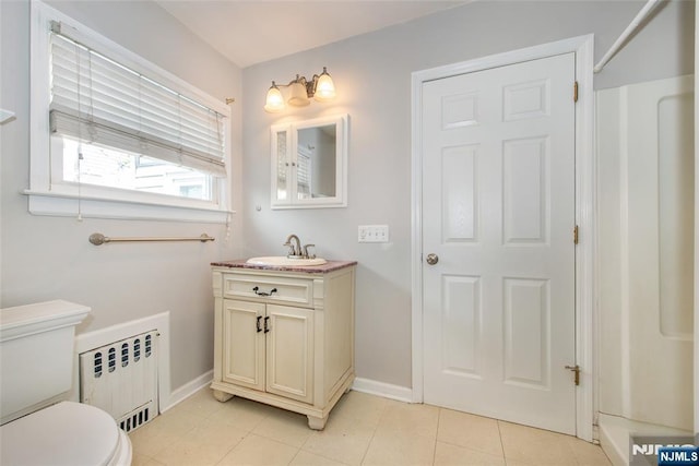 516 5th St, Carlstadt, NJ 07072 - full bath with tile patterned floors, baseboards, vanity, toilet, and radiator
