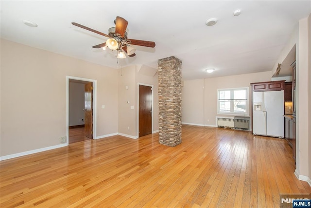 516 5th St, Carlstadt, NJ 07072 - unfurnished living room with ceiling fan, light wood finished floors, radiator, baseboards, and decorative columns