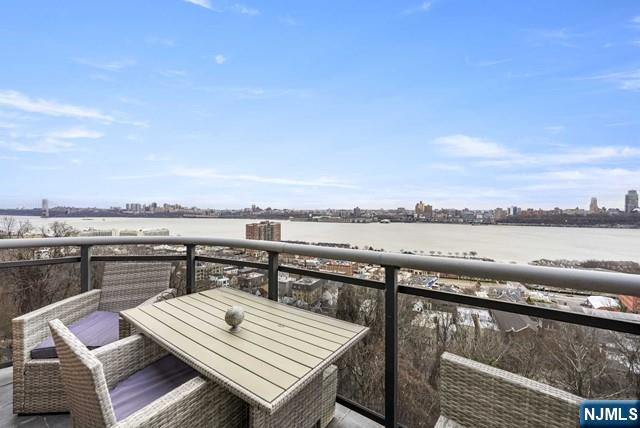 balcony with a water view and a city view