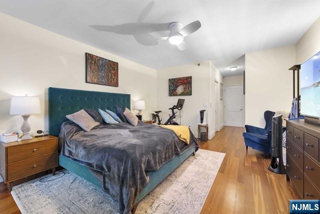 bedroom with a ceiling fan and wood finished floors
