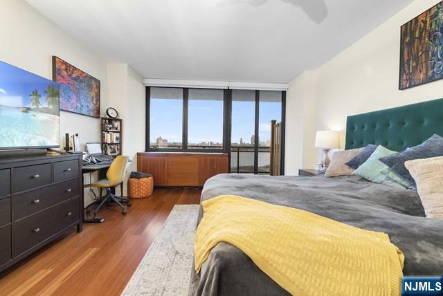 bedroom featuring a ceiling fan and wood finished floors