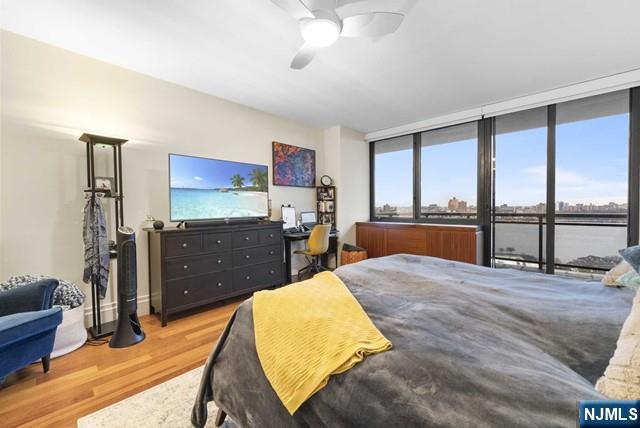 bedroom with ceiling fan and wood finished floors