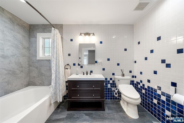 bathroom with visible vents, tile walls, vanity, toilet, and shower / bathtub combination with curtain