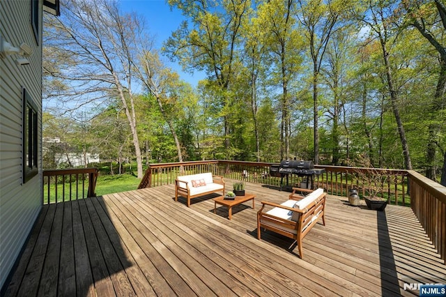 wooden deck with outdoor lounge area and a grill