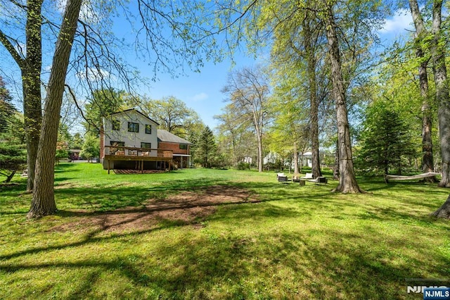 view of yard with a wooden deck