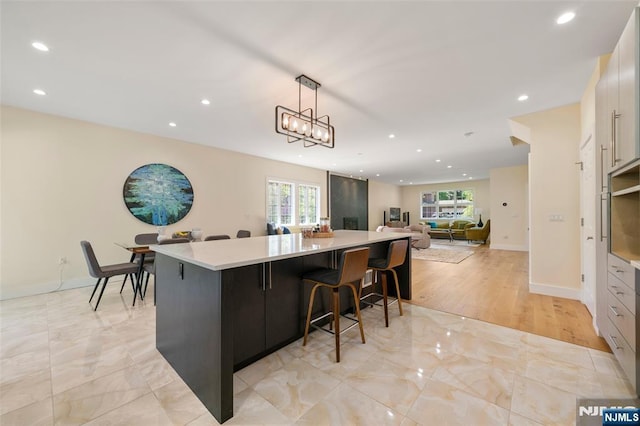 bar with recessed lighting, decorative light fixtures, baseboards, and marble finish floor