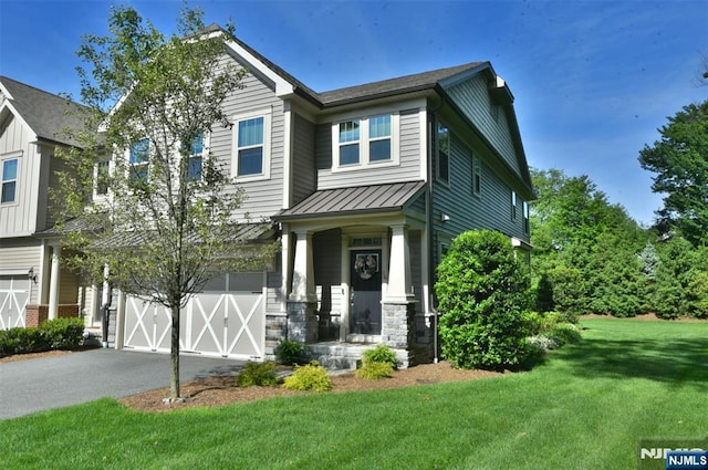 16 Marilyn Dr, Woodcliff Lake, NJ 07677 - craftsman-style house with a front yard, a garage, driveway, a standing seam roof, and stone siding
