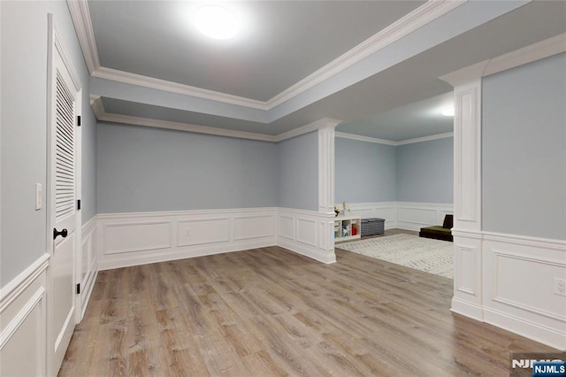 16 Marilyn Dr, Woodcliff Lake, NJ 07677 - empty room featuring a decorative wall, wood finished floors, ornamental molding, and wainscoting