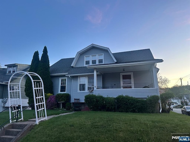 28 Hutchinson Ave, Hawthorne, NJ 07506 - colonial inspired home with a front lawn, roof with shingles, a porch, and cooling unit