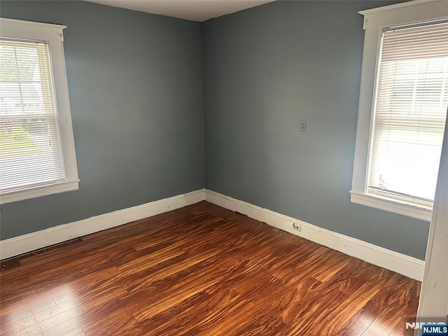 28 Hutchinson Ave, Hawthorne, NJ 07506 - spare room featuring dark wood-style floors, baseboards, and healthy amount of natural light