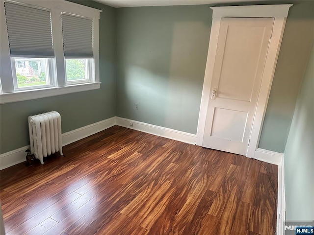 28 Hutchinson Ave, Hawthorne, NJ 07506 - unfurnished room featuring radiator, dark wood finished floors, and baseboards