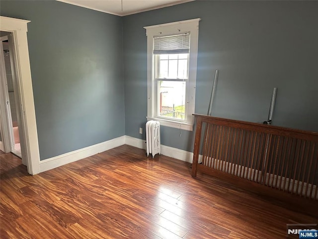 28 Hutchinson Ave, Hawthorne, NJ 07506 - spare room featuring radiator, wood finished floors, baseboards, and ornamental molding
