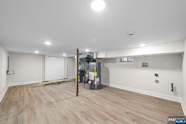 165 Jerome Pl, Bloomfield, NJ 07003 - finished basement featuring baseboards, heating unit, wood finished floors, and gas water heater