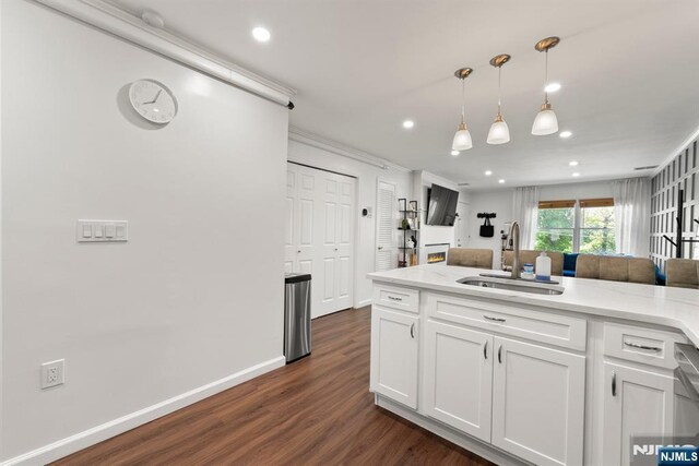 kitchen featuring recessed lighting, a sink, white cabinetry, and dark wood-style floors