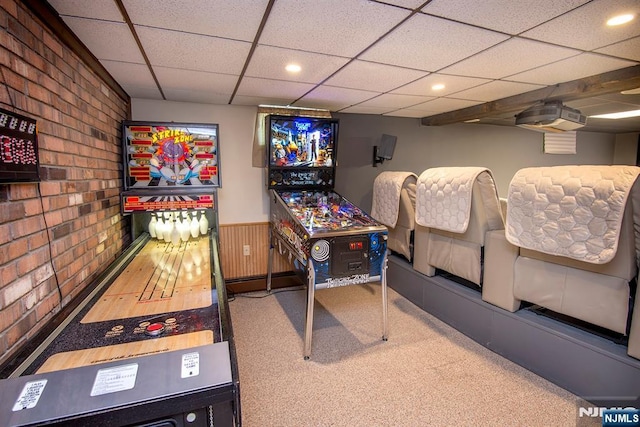 game room with recessed lighting, carpet flooring, brick wall, wainscoting, and a paneled ceiling