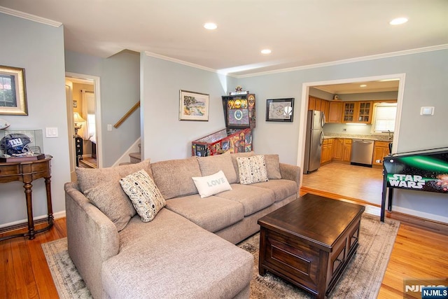 living room with stairs, recessed lighting, light wood-style flooring, and crown molding