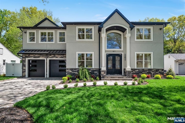view of front of property with an attached garage, a front lawn, stucco siding, decorative driveway, and french doors
