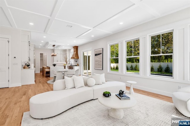living room featuring baseboards, recessed lighting, coffered ceiling, and light wood finished floors