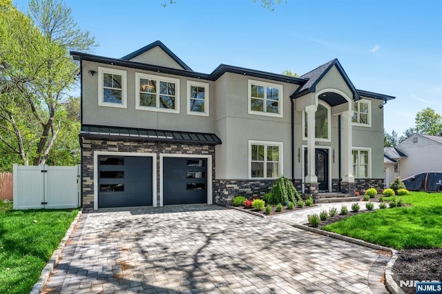 view of front of property featuring stucco siding, decorative driveway, and fence