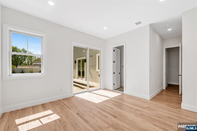 unfurnished bedroom featuring visible vents, baseboards, recessed lighting, access to outside, and light wood-type flooring