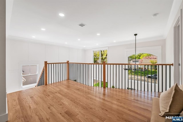 hall with crown molding, recessed lighting, wood finished floors, and visible vents