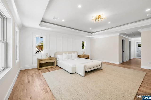 bedroom featuring multiple windows and light wood-style flooring