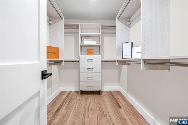walk in closet featuring light wood finished floors