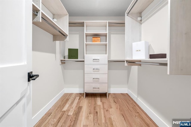spacious closet with light wood finished floors