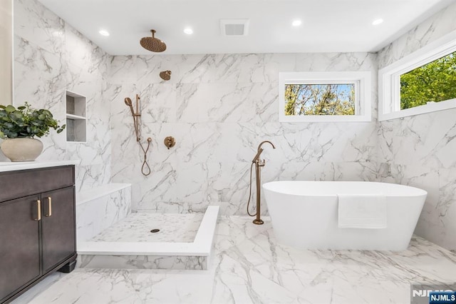 full bath featuring a freestanding bath, a marble finish shower, recessed lighting, and marble finish floor