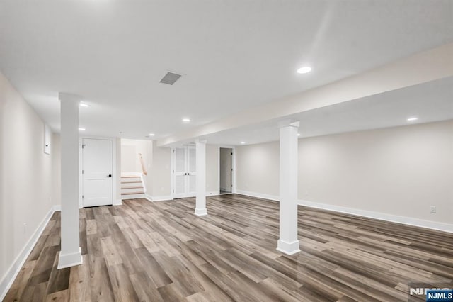 finished basement with baseboards and wood finished floors