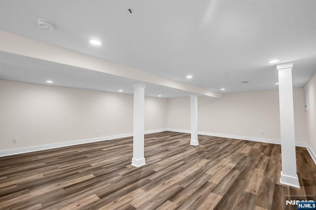 finished basement with baseboards, recessed lighting, and wood finished floors