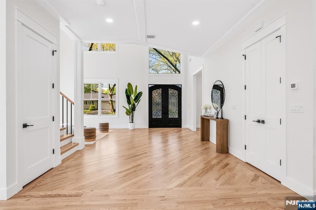 entrance foyer with recessed lighting, baseboards, visible vents, and stairway