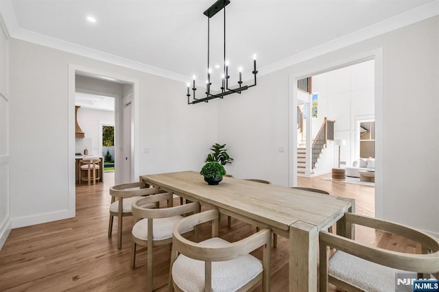 dining space featuring crown molding, stairs, baseboards, recessed lighting, and light wood finished floors