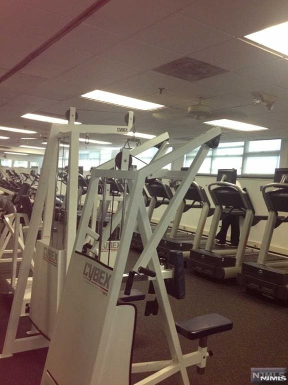 exercise room featuring a drop ceiling