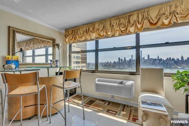 interior space featuring crown molding, tile patterned flooring, a wall mounted air conditioner, a textured ceiling, and a city view
