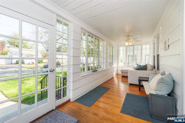 sunroom featuring ornamental molding and hardwood / wood-style flooring