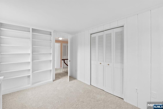 unfurnished bedroom with carpet floors and multiple closets