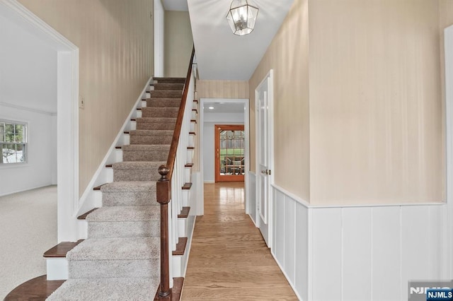 stairs featuring wood finished floors