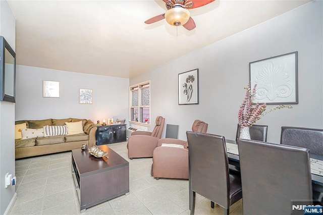 living area featuring tile patterned flooring and a ceiling fan