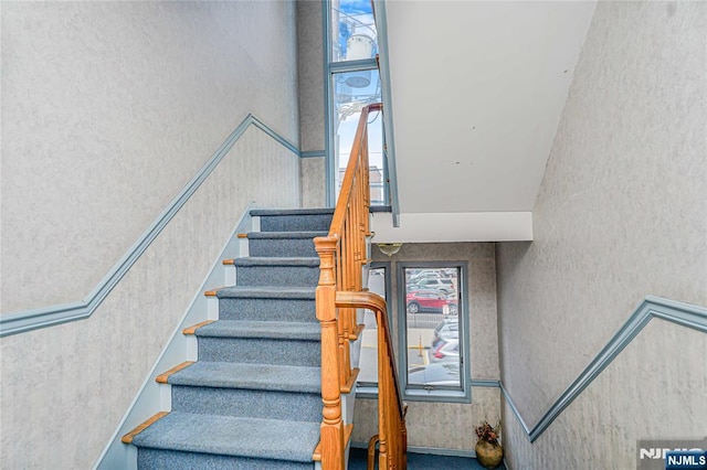 stairs with wallpapered walls