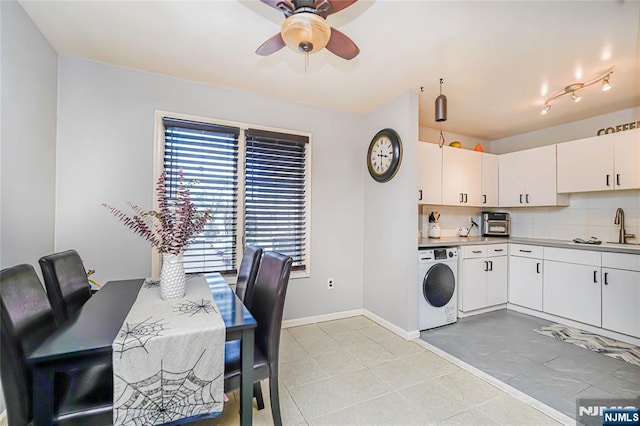 kitchen featuring ceiling fan, backsplash, washer / clothes dryer, baseboards, and white cabinets