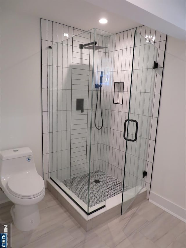 full bath with a stall shower and toilet