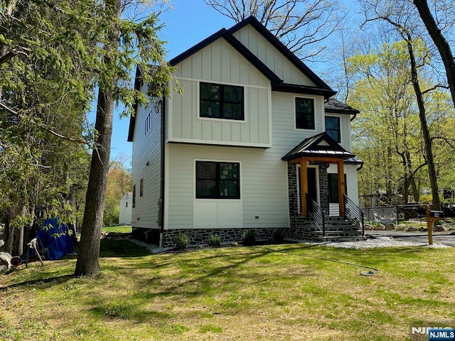 view of front of house featuring board and batten siding and a front lawn