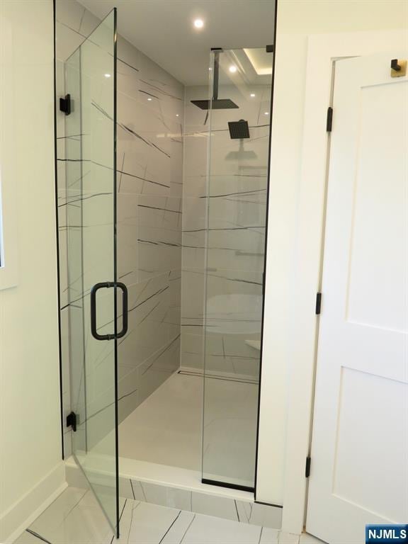 bathroom with recessed lighting and a stall shower